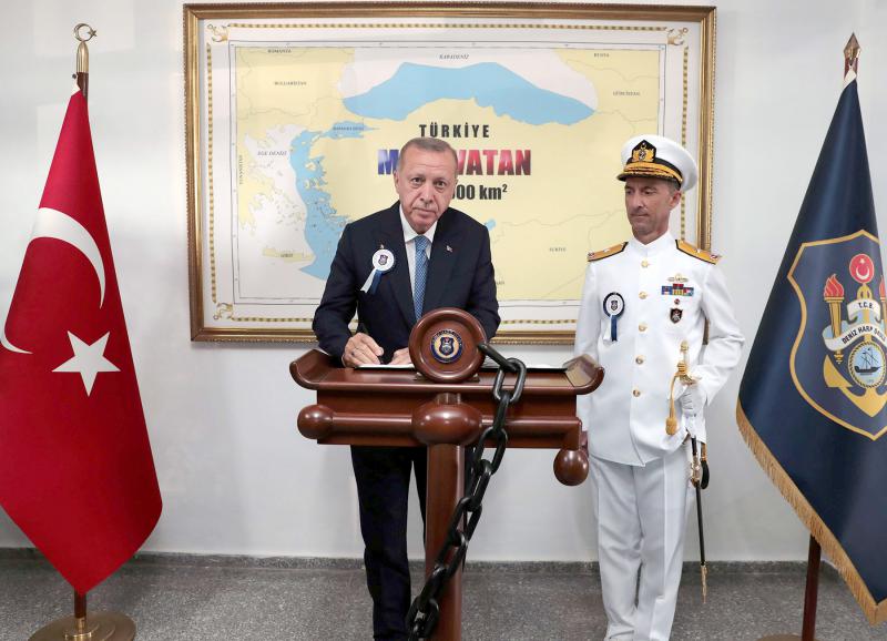 Turkish-President-Tayyip-Erdogan-with-a-Blue-Homeland-map-in-the-background-is-pictured-during-a-ceremony-at-the-Naval-Academy-in-Istanbul