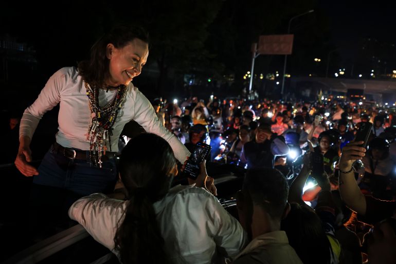 Machado greets the crowd gathered around her vehicle amid supporters in Caracas, Venezuela, on October 25, 2026