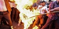 پرچم سوئد در تهران به آتش کشیده شد+ تصاویر
